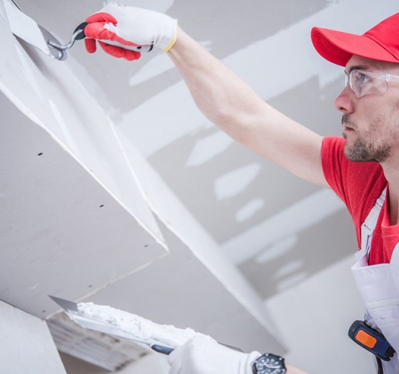 Drywall specialist applying joint compound